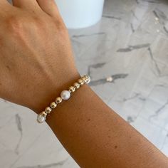 This 7mm gold ball and 8mm freshwater pearl bracelet is perfect for any stack and goes with any outfit! Pair with all gold ball collection bracelets for a perfect stacked look! White Pearl Stackable Bracelets, White Stackable Adjustable Pearl Bracelet, White Beaded 14k Gold-filled Bracelets, Luxury Gold-plated Stackable Bracelets, White 14k Gold-filled Round Beaded Bracelet, Freshwater Pearl Bracelet, Pearl Bracelet, Fresh Water, Freshwater Pearls