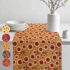 a table topped with plates and vases next to a yellow table cloth covered in circles