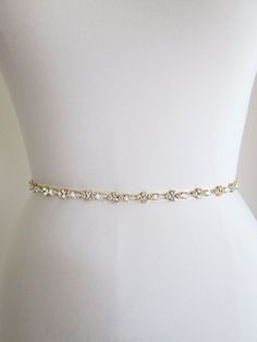 "This sparkly skinny bridal belt is made with Swarovski crystals beaded on 3/8\" wide grosgrain ribbon. The crystal part of the belt measures 24\" long and 3/8\" wide. The entire sash measures 150\" long. Available in gold, silver and rose gold finish. This belt can be made with organza, satin or grosgrain ribbon. * this belt can be made in any length, please inquire about a different length and pricing - For the photos of this belt in silver finish please take a look here: https://www.etsy.com/ Adjustable Bridal Belt With Sashes For Party, Adjustable Bridesmaid Bridal Belt With Sashes, Adjustable Bridal Belt With Sashes For Bridesmaid, Adjustable Sashes Bridal Belt For Party, Adjustable Bridal Belt For Wedding, Wedding Belts With Sashes, Elegant Adjustable Bridal Belt, Elegant Gold Fitted Bridal Belt, Elegant Fitted Gold Bridal Belt