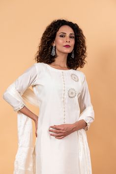 The fabric of this set is silk and it features intricate sequin work. The neckline is a zero-neck design and the 3/4th length sleeves add to its elegance. The set includes a kurta, trousers, and dupatta, making it a total of two components. Elegant Slub Silk Sets With Mirror Work, Formal Sets With Mirror Work And Straight Kurta, Elegant Cotton Silk Palazzo Set With Mirror Work, Elegant Cotton Silk Salwar Kameez With Mirror Work, Festive Cotton Silk Kurta With Set-in Sleeves, Traditional Kurta With Set-in Sleeves For Eid, Elegant Slub Silk Anarkali Set With Straight Kurta, Elegant Cotton Silk Sets For Festivals, Formal Bollywood Cotton Silk Sets