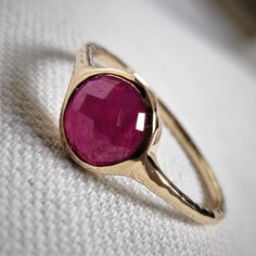 This stunning ring is set in 14k Solid Yellow Gold with Natural Ruby with utmost precision. It is a unique statement gemstone ring for nearly every occasion and is completely hassle-free jewelry. ITEM DETAILS: * GEM: Ruby * GEM SIZE: 7mm * GEM SHAPE: Round * SIDE GEM: Pink Tourmaline * GEM SIZE: 3mm (12 pcs) * GEM SHAPE: ROUND * Total Gem weight: 1.65 carats * Gold Purity: 14KT  * Gold Weight: 1.31 gram * Total Weight of the Ring: 1.64 gram The Gold purity is guaranteed and it comes with an auth Faceted Sapphire Ring In 14k Gold, 14k Gold Faceted Sapphire Ring, Ruby Ring In Yellow Gold With Bezel Setting, Yellow Gold Ruby Ring With Bezel Setting, Faceted Emerald Ring Fine Jewelry, Anniversary Ruby Ring With Bezel Setting, Fine Jewelry Faceted Emerald Ring, Ruby Ring With Bezel Setting In Fine Jewelry Style, Stackable Ruby Ring Fine Jewelry