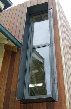 an open window on the side of a wooden building