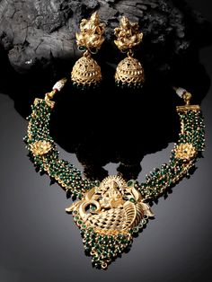 Gold-Plated Stones Studded Beaded Temple Jewelry Necklace With Earrings Set/Bollywood Jewelry/Navratri Diwali Jewelry/Statement Jewelry Main Stone: Artificial Stone Plating: Golden Plated Stone Cut : Round Color : Green Metal: Alloy Closure: Post and Back Size & Fit: Length of Necklace: 22 cm Length of Earrings: 5.5 cm each Material & Care: Alloy and Artificial beads Care Instructions: Wipe your jewellery with a soft cloth after every use Always store your jewellery in a flat box to avoid accidental scratches Keep sprays and perfumes away from your jewellery Do not soak your jewellery in water,Clean your jewellery using a soft brush,Dipped in jewellery cleaning solution only ADIVA Jewelry set is the identity of Indian women and a symbol of grace. These earrings include an insight of crude Festival Kundan Temple Necklace With Peacock Design, Festive Kundan Temple Necklace With Peacock Design, Temple Jewelry Bridal Necklace With Latkans For Eid, Cutdowna Jewelry Sets For Puja During Diwali, Peacock Design Jhumkas For Puja And Festivals, Peacock Design Jhumkas For Navratri Puja, Festive Peacock Design Jhumkas For Puja, Navratri Peacock Design Jhumkas For Puja, Navratri Puja Peacock Design Jhumkas