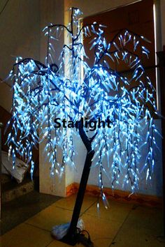 a lighted tree in the middle of a hallway