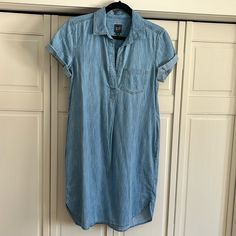 Short Sleeved Gap Chambray Shirt Tail Front Dress With Pleat In Front And Back. Rolled Sleeves. Two Side Pockets. Length Hits At Knee, Depending On Height (I’m 5’3”). In Perfect Condition. Never Worn. Tail Dress, Chambray Shirt Dress, Dress With Pleats, World Countries, Rolled Sleeves, Gap Dress, Chambray Shirt, Fast Fashion, Natural Organic