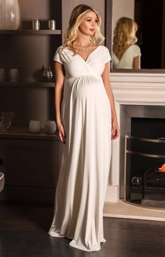 Sleek and elegant, our Francesca Wedding Gown in dreamy ivory white glides over your pregnancy curves in luxurious soft-sheen jersey. With a crossover neckline and grow-on sleeves that can be worn on or off-the-shoulder, this maternity dress fits and flatters in all the right places. Ivory white luxe jersey with subtle sheen Flattering cross-over neckline Stretch for comfort Floaty full-length skirt Fully lined Perfect for all stages of pregnancy Made in Britain Pregnancy Gowns Dresses Tiffany Rose Maternity, Wedding Dresses For Pregnant Brides Tiffany Rose Maternity, Rose Tiffany, Estilo Meghan Markle, Spring Wedding Outfit, Pregnant Bride, Tiffany Rose, Sparkly Prom Dress, Dresses For Pregnant Women