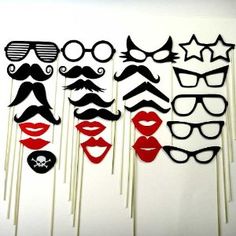 a bunch of fake moustaches and mustaches on sticks