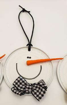 a paper plate with a smiling face and carrots attached to it