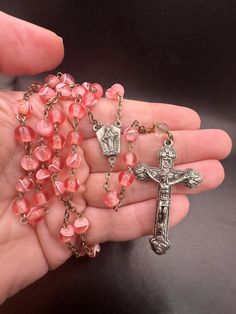 Great vintage rosary!  Pink beads with the exception of the last bead on the piece before the crucifix is clear.  In good vintage condition! Wear on finish. Vintage Cross Jewelry With 8mm Beads, Vintage Rosary Bracelet With Round Beads As Gift, Vintage Cross Necklaces With 8mm Beads, Vintage Cross Necklace With 8mm Beads, Handmade Adjustable Vintage Rosary Bracelet, Vintage Rosary With Round Beads As Gift, Vintage Beaded Rosary As Gift, Handmade Silver Vintage Rosary, Handmade Vintage Silver Rosary