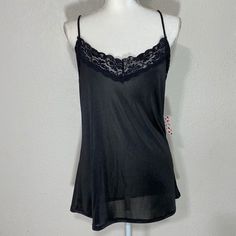 Free Kisses Black Camisole Tank Blouse Size: Large Color: Black Approximate Measurements Pit To Pit: 20in Length: 24in New With Tag Flirty Camisole With Built-in Bra For Night Out, Black Stretch Camisole With Spaghetti Straps, Black V-neck Tank Top With Adjustable Straps, Black Camisole With Adjustable Tank Straps, Black Seamless Camisole For Party, Black Camisole With Tank Straps, Black Camisole With Adjustable Spaghetti Straps, Flirty Cami Tank Top With Lace Trim, Black Flirty Tank Top For Summer