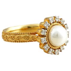 Gold(14K): 6.50g Brilliant cut Diamonds (VS clarity & H-I colour): 0.26ct Gemstone: Cultured Pearl Classic and evergreen, the Zoe ring has been handcrafted in gold and holds a white cultured pearl at its heart. The prong-set diamonds surrounding the pearl add to its elegance and sophistication. Luxury Pearl Ring For Anniversary With Intricate Design, Luxury Stackable Yellow Gold Pearl Ring, Luxury Heirloom Pearl Ring With Polished Finish, Luxury Pearl Ring With Center Stone For Anniversary, Luxury Pearl Gemstone Ring For Anniversary, Oval Yellow Gold Pearl Ring With Halo Setting, Formal Yellow Gold Pearl Ring With Halo Setting, Yellow Gold Diamond Pearl Ring With Halo Setting, Formal Pearl Ring With Diamond Halo Design