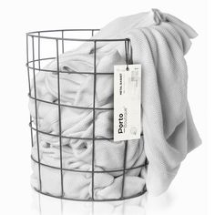 a wire basket filled with white towels and a tag on it's side that says pro laundry