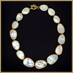 An iconic design, beautiful and timeless. Graduated, irregularly shaped petals of mother-of-pearl, each surrounded by a brushed golden edge. The natural mother-of-pearl nacre has a lustrous sheen that contains a rainbow of colors, changing with the light. Lightweight and delicate, and perfectly proportioned. Toggle clasp for easy on/off. 16" long, with petals that range from 3/4" to 1.25" in length. Imported for the Leila Jewels Glam Collection Elegant Shell Jewelry With Natural Stones, Formal Necklace With High Luster Mother Of Pearl, Elegant Jewelry With Natural Stones And Shell Shape, Elegant Jewelry With Natural Shell Stones, Formal Mother Of Pearl Necklace With High Luster, Pearl Chain Shell Necklace, Elegant Mother Of Pearl Shell Necklaces, Handmade Mother Of Pearl Shell Necklace, Elegant White Shell Necklace With Natural Stones