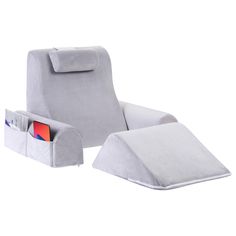 a white chair with an arm rest and magazine holder in it's back pocket