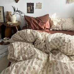 a bed with many pillows and blankets on it