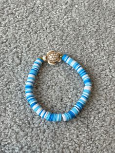 a blue and white beaded bracelet on carpet