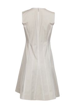 Form meets function in this sleeveless beige dress by Lafayette 148. Eye-catching contrast stitching is the focal point, elevating this simple piece into wardrobe staple. Wear with sneakers in the summer months, or knee-high snake skin boots in the fall for a truly stylish look. Size 2 66% Cotton, 25% Polyamide, 9% Elastane Rounded collar w/ v-opening Concealed back zipper Contrast stitched pleats Bust 36" Waist 29" Shoulder to hem 37" White Sleeveless Dress With French Seams, Fitted Summer Dress With Seam Detailing, Fitted Summer Dress With Contrast Stitching, Chic Spring Dress With Seam Detailing, Beige A-line Sleeveless Cotton Dress, Beige Cotton A-line Sleeveless Dress, Fitted Beige Sleeveless Dress For Work, Neutral Fitted A-line Dress, Snake Skin Boots