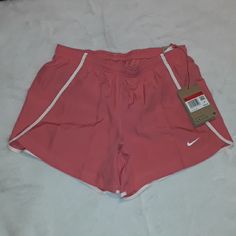 Coral Pink With White Trim Dri-Fit Inside Tie, Pocket And Lining Pink Sports Shorts For Spring, Pink Workout Shorts For Spring, Pink Athletic Shorts For Spring Workout, Pink Summer Workout Shorts, Summer Workout Shorts In Pink, Nike Pink Athletic Shorts For Summer, Pink Summer Sports Bottoms, Summer Sports Pink Bottoms, Summer Stretch Pink Athletic Shorts