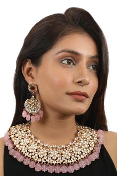 22kt matt gold plated necklace with light pink beads& jadtar embellishments. Comes with embellished chandbalis.
Components: 1 Necklace, Pair of Earrings
Type: Real jadtar stones, semi precious, pearls, glass bleads
Composition: Silver + Copper Mix, 22kt Gold Plating
Color: Pink, White
Other Details: 
Size (in cms): L x W:
Necklace: 7 x 26
Earrings: 10 x 3.5
Closure:
Necklace: Adjustable thread
Earrings: Pushback clasp
 - Aza Fashions Jadtar Necklace Set, W Necklace, Thread Earrings, Pink Beads, Gold Plated Necklace, Aza Fashion, White Silver, Gold Plating, Bridal Style