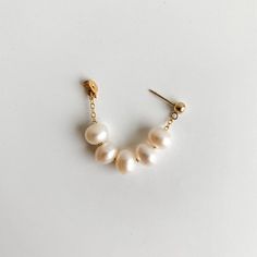 Discover the exquisite look of our Eilis Freshwater Pearl Wrap Around Earrings. Lustrous oval pearls in a contemporary wrap around style, drapes from front to back. This timeless accessory adds a touch of modernity to any ensemble. -- 14k Gold Filled pearls: 5x7mm Cheap Handmade Elegant Wrap Earrings, Affordable Trendy Wrap Earrings For Gifts, Luxury Handmade Minimalist Jewelry, Wire Wrapped Pearl Earring, Gold Earring Wrap, Luxury Pearl Wedding Earrings With Ear Wire, Affordable Adjustable Pearl Jewelry, Affordable Trendy Pearl Jewelry, Unique Luxury Wrap Earrings For Gift