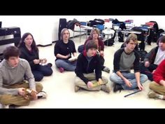 a group of young people sitting on the floor