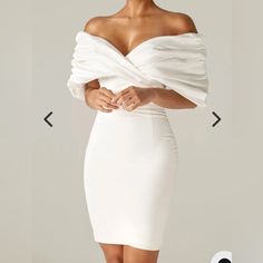 Made From A Luxurious Soft Heavyweight Crepe That Really Sculpts And Shapes Your Figure To Cinch Your Waist And Create The Perfect Figure Hugging Silhouette. The Oversized Satin Ruffles To The Shoulders Add Drama Yet It Sits Perfectly In An Off Shoulder Cut. The Boning Detailing Extends Down To The Waist In A Pretty Shape And Through The Back And Sides To Really Exaggerate The Curves And Underwired Cups Design Means You Don't Need A Bra. - Lining: Fully Lined - Made From: Crepe And Satin Fabrics - Stretch Factor: 1/3 - Dress Length: Approx. 36" In - Material: Crepe (95% Polyester, 5% Elastane), Satin (97% Polyester, 3% Elastane) - Care: Gentle Dry Clean Only Elegant White Off-shoulder Midi Dress, Elegant Draped Midi Dress For Brunch, Elegant White Draped Midi Dress, Elegant Off-shoulder Mini Dress For Brunch, White Ruffled Sheath Dress, White Sheath Dress With Ruffles, White V-neck Dinner Dress, Elegant White Ruched Mini Dress, White Dressy Ruffled Dress