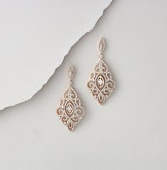 "Sparkly Rose Gold finish earrings are set with Swarovski Pure Brilliance stones in a vintage filigree design. You will fall in love with these beauties ! Available in rose gold, yellow gold and rhodium finish Earrings measure 2.25\" L x 1\" W Matching bracelet: https://www.etsy.com/listing/495588441/rose-gold-bracelet-wedding-jewelry?ref=listing-shop-header-0 https://www.etsy.com/listing/674474135/rose-gold-bridal-bracelet-teardrop?ref=shop_home_active_1&pro=1&frs=1" Wedding Earrings With Intricate Cubic Zirconia Design, Wedding Earrings With Intricate Design In Cubic Zirconia, Intricate Cubic Zirconia Earrings For Wedding, Wedding Diamond Drop Earrings With Intricate Design, Anniversary Bridal Earrings With Intricate Cubic Zirconia Design, Intricate Design Diamond Drop Earrings For Wedding, Cubic Zirconia Chandelier Earrings With Intricate Design As Gift, Intricate Cubic Zirconia Chandelier Earrings As Gift, Gift Cubic Zirconia Chandelier Earrings With Intricate Design