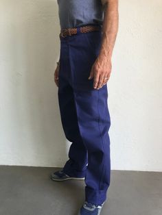 "French blue work trousers - Macober Made in France 1970s High waist pants in indigo blue sanforized cotton . Straight cut with crease. 5 button closure. Bakelite buttons. All originals. 2 side pockets, 1 buttoned back pocket. 5 belt loops. In perfet condition. New item. Deadstock With original cardbord label . Never washed. Label size: 42/10 The model usually wears a size M (40/42) and measurs 175cm - 68,8,\" Measurements (flat): Waist: 40cm - 15,7\" Hips: 57cm - 22,4\" Crotch: 34cm - 12,5\" fr Cotton Work Pants With Belt Loops, Blue Cotton Work Pants With Pockets, Blue Straight Leg Work Pants With Belt Loops, Retro Style Denim Blue Cotton Pants, Vintage Denim Blue Cotton Pants, Retro Cotton Pants With Standard Cut Leg, Navy Cotton Tapered Leg Work Pants, Retro Cotton Pants With Standard Cut, Retro Work Pants With Pockets