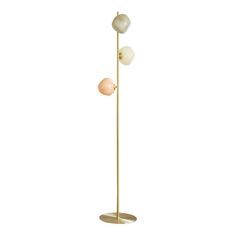 the three light floor lamp is shown in gold, white and pink tones with an oval base