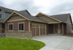 a house with two car garages on the side of it