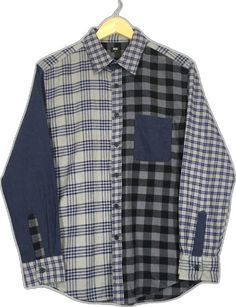 a black and white checkered shirt hanging on a hanger with a yellow tag