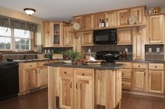 a kitchen with wooden cabinets and black appliances