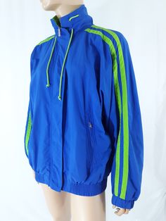 "Women's Unisex Athletic Jacket Sportswear Outerwear Blue Green Stripe Jogging Classic Excellent Condition Vintage Size M by LIZ SPORT Super cool rad! Vivid Blue with vivid green sports striped trim, inside netting and various cool details. Zippered Pockets, drawstring collar, elastic waist and cuffs, vented and oversized, zipper front and velcro closures. Men's women's unisex athletic classic jacket. Super fun! Excellent condition. High quality. Easy to wear casual chic vintage for the disco sp Blue Long Sleeve Training Outerwear, Moisture-wicking Blue Outerwear For Workout, Blue Long Sleeve Outerwear For Training, Blue Moisture-wicking Outerwear For Workout, Blue Stretch Track Jacket, Blue Long Sleeve Workout Track Jacket, Functional Blue Nylon Track Jacket, Functional Blue Outerwear For Training, Blue Winter Training Outerwear