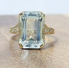 This vintage ring is a stunning piece of fine jewelry, perfect for special occasions such as engagement, wedding, anniversary, birthday, Valentine's Day, Christmas, or Mother's Day. Gorgeous Vintage 14k yellow gold natural blue aquamarine in a rectangular shape  center weight 5.52ct. size 13.8x8.7mm very nice light sky blue color  nice luster, very lively, and nice cut. Eye Clean aquamarine Brilliant, sparkly. side  round cut diamonds total weight 0.08ct ring size 5 Resizable  Appraisal availabl Aquamarine Engagement Ring Art Deco, Luxury Formal White Gold Topaz Ring, Luxury Birthstone Engagement Ring With Smooth Bezel, Luxury Moissanite Birthstone Ring In Fine Jewelry Style, Luxury Topaz Ring With Center Stone, Baguette Cut, Aquamarine Gemstone Ring, Aquamarine Emerald Cut Ring, Engagement Rings Light Blue, Expensive Engagement Rings Unique