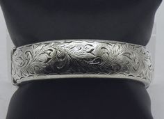 "Beautiful vintage English sterling silver wide hinged bangle, with beautiful engraved designs. The bangle is made by Harrod's Stores, Ltd. 2 1/2 x 2 1/4\" interior  2 3/4 x 2 1/2 x 3/4\" exterior Marked with Birmingham assay office mark, 1962-1963 date mark, and \"H.S. LTD\" maker's mark" Victorian Bracelet, Cameo Bracelet, Silver Bangle Bracelets, Blue Quartz, Maker's Mark, Hinged Bangle, Vintage Bracelets, Chain Link Necklace, Vintage 1960s