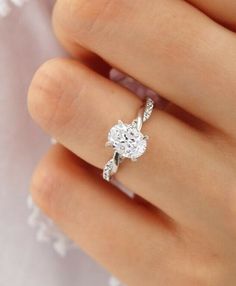 a woman's hand with a diamond ring on it