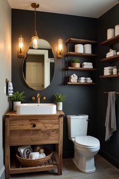 a white toilet sitting next to a wooden sink vanity in a bathroom under a round mirror