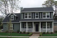 a gray house with white trim and black shutters