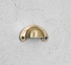 a close up of a metal handle on a white marble counter top with black dots