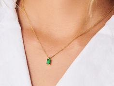 A dainty stone and delicate metallic chain are combined to create this Gold Pendant Necklace in bright emerald, your new favorite wear-anywhere accessory. Emerald is the birthstone of May. High quality lab created emerald stone Made of 14K gold plated sterling silver Pendant size: 10mm x 6mm with 16" chain Hypoallergenic, nickel and lead free Tarnish resistant Everyday Fine Jewelry Green Necklaces, Everyday Fine Jewelry Green Necklace, Green Fine Jewelry Necklace For Everyday, Silver Emerald Pendant Necklace, Dainty Green Jewelry With Delicate Chain, Green Delicate Chain Jewelry For May Birthstone, Delicate Green Necklace With May Birthstone, Green Delicate Chain Jewelry For Everyday, Delicate Green May Birthstone Necklace