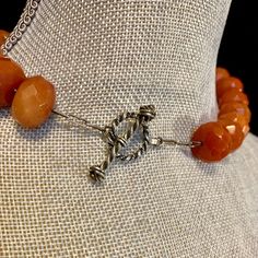 "This gorgeous carnelian choker features 27 large faceted amber color beads. Each bead is .625\" wide x .325\" thick. The over all length is approximately 17.75\". The tiny spacer beads are sterling silver. It is finished with a handmade silver toggle clasp. Length 16\" Width .625\" Additional Information: * Complimentary Gift Box! * All jewelry items come securely packaged and are mailed promptly upon payment - often same-day. * The majority of my vintage items are used and may show some wear. Orange Round Faceted Beads Jewelry, Faceted Amber Round Bead Jewelry, Adjustable Carnelian Jewelry With Faceted Beads, Faceted Orange Beaded Necklace As Gift, Gift Carnelian Faceted Beads, Spiritual Orange Jewelry With Faceted Beads, Amber Faceted Bead Necklaces For Jewelry Making, Faceted Amber Beaded Necklaces For Jewelry Making, Amber Faceted Beads For Jewelry Making