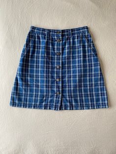 Details:  90s, liz wear, blue plaid button down mini skirt Condition:  Item is in excellent condition with no noted flaws *(this skirt has been washed and sanitized) Measurements: (all measurements taken flat in inches, then doubled where appropriate) Waist: 28 Hip: 36 Length: 19 Label Size: 10 (this would fit more like a modern-day size 6) Fabric Content:  100% cotton Care Instructions: Machine wash cold with like colors, tumble dry low heat or hang dry Return Policy: I do not accept returns, h Blue Button-up Cotton Denim Skirt, Blue Cotton Button-up Denim Skirt, Fitted Blue Denim Skirt For School, Preppy Blue Cotton Skirt, Retro Blue Cotton Denim Skirt, Blue Retro Cotton Skort, Retro Blue Cotton Skort, Cotton Denim Mini Skirt For School, Cotton Mini Denim Skirt For School