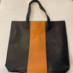 Mcm Parfums Black And Tan Faux Leather Tote Bag. Never Used And In Perfect Condition. Black Shoulder Bag For Business In Fall, Black Leather Shoulder Bag For Fall, Black Leather Bags For Fall, Luxury Brown Faux Leather Bag, Black Textured Leather Bag For Daily Use, Black Leather Lined Tote Bag, Black Leather-lined Shoulder Bag, Fall Soft Leather Black Bag, Brown Textured Faux Leather Shoulder Bag