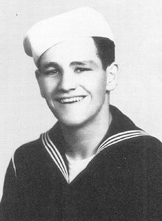 a black and white photo of a man in a sailor's uniform with the words phm2 jack bradley