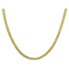 This extraordinary fancy yellow diamond tennis necklace redefines the classic tennis necklace with a bold and vibrant twist. Featuring 18.18 carats total of 161 perfectly matched fancy yellow cushion-cut diamonds, this piece radiates warmth and brilliance from every angle. Each diamond is meticulously selected for VS+ clarity, ensuring exceptional sparkle and quality. Measuring 17 inches in length, this necklace is crafted in luxurious 14k yellow gold, designed to seamlessly complement the vibra Gold Baguette Diamond Tennis Necklace Gift, Gold Tennis Necklace With Baguette Diamonds, Formal Yellow Necklace With Brilliant Cut, Gold Necklaces With Baguette Diamonds, Yellow Diamond-cut Necklace In Fine Jewelry Style, Yellow Diamond Fine Jewelry Necklace, Yellow Diamond Necklace In Fine Jewelry Style, Yellow Diamond Cut Necklace In Fine Jewelry Style, Fine Jewelry Yellow Diamond Necklace