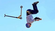 a man flying through the air while riding a skateboard in front of a blue sky