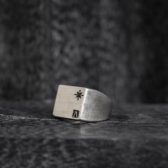 Introducing the Oval Signet Ring - a reworked design that exudes elegance and sophistication. This ring features the iconic message ____ engraved around the crown, serving as a reminder of the wearer's triumphs and accomplishments. Crafted in the classic signet ring style, this piece is a timeless addition to any jewelry collection. The oval shape adds a modern touch, while the intricate details showcase the expert craftsmanship. With its meaningful message and beautiful design, this ring is perfect for those who want to make a statement and leave a lasting impression. "All conditioned things are Impermanent."-Sterling silver 925.-Size: 20mm by 15mm. Thickness 1-2mm.-Engraved around the crown. Specifications -Signet Ring style, reworked design. -Sterling silver 925. -Size: 20mm by 15mm. Th Luxury Silver Rings With Etched Details, Classic Formal Rings With Engraved Logo, Elegant Formal Ring With Engraved Logo, Elegant Formal Rings With Engraved Logo, Classic Promise Engraved Ring, Classic Formal Jewelry With Engraved Logo, Elegant Engraved Logo Ring For Formal Occasions, Classic Ring With Engraved Logo, Luxury Sterling Silver Engraved Open Ring