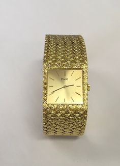 "Genuine Piaget watch with a manual movement in 18 karat yellow gold with a woven 18 karat yellow gold bracelet.  The watch measures 7\" long and 7/8\" wide.  It has a square case and gold stick dial.  Watch is in excellent condition and was serviced 1/9/2021.  Preowned.  Serial # 362124.  Model # 9352D2." Piaget Watch, Fancy Watches, Luxury Bags Collection, Titanium Watches, Cad Blocks, Vintage Watches For Men, Crosses Decor, Cartoon Wallpaper Iphone, Cartier Watch