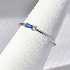 SOLID STERLING SILVER dainty ring with a sapphire-colored (navy blue) rectangular-shaped gemstone. The unique jewelry you can find, a perfect gift for you and your loved one. It's dainty but sturdy and can be worn every day. A special piece you'll truly treasure! High-quality materials and attention to detail. High polished finish. The price is for ONE ring. This dainty, elegant, but sturdy ring comes in a gift box. SIZING INFO: Please be sure you have the correct ring size before making your pu Adjustable Sapphire Ring In Fine Jewelry Style, Minimalist Crystal Diamond Ring With Birthstone, Minimalist Diamond Birthstone Crystal Ring, Modern Sterling Silver Birthstone Ring For Promise, Adjustable Sapphire Ring Fine Jewelry, Sapphire Stackable Rings With Prong Setting As Gift, Modern Sterling Silver Sapphire Ring As A Gift, Sterling Silver Birthstone Ring Fine Jewelry, Sapphire Sterling Silver Jewelry For Promise