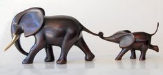 two small figurines of elephants walking side by side